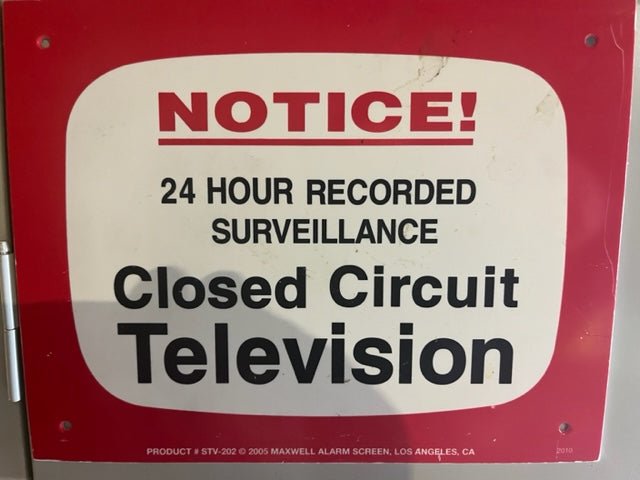 Technician servicing an IP/PoE security camera for managed video surveillance in Austin, Texas